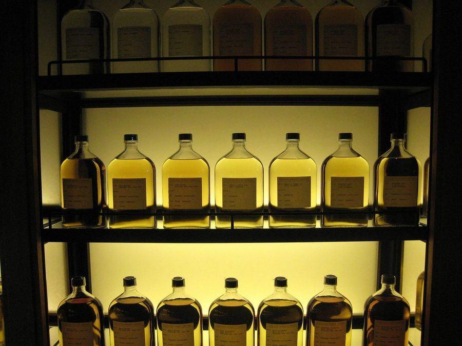 Spirit bottles displayed on illuminated shelves
