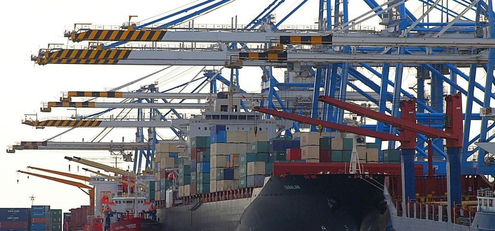 Container ship alongside gantry cranes at an international terminal